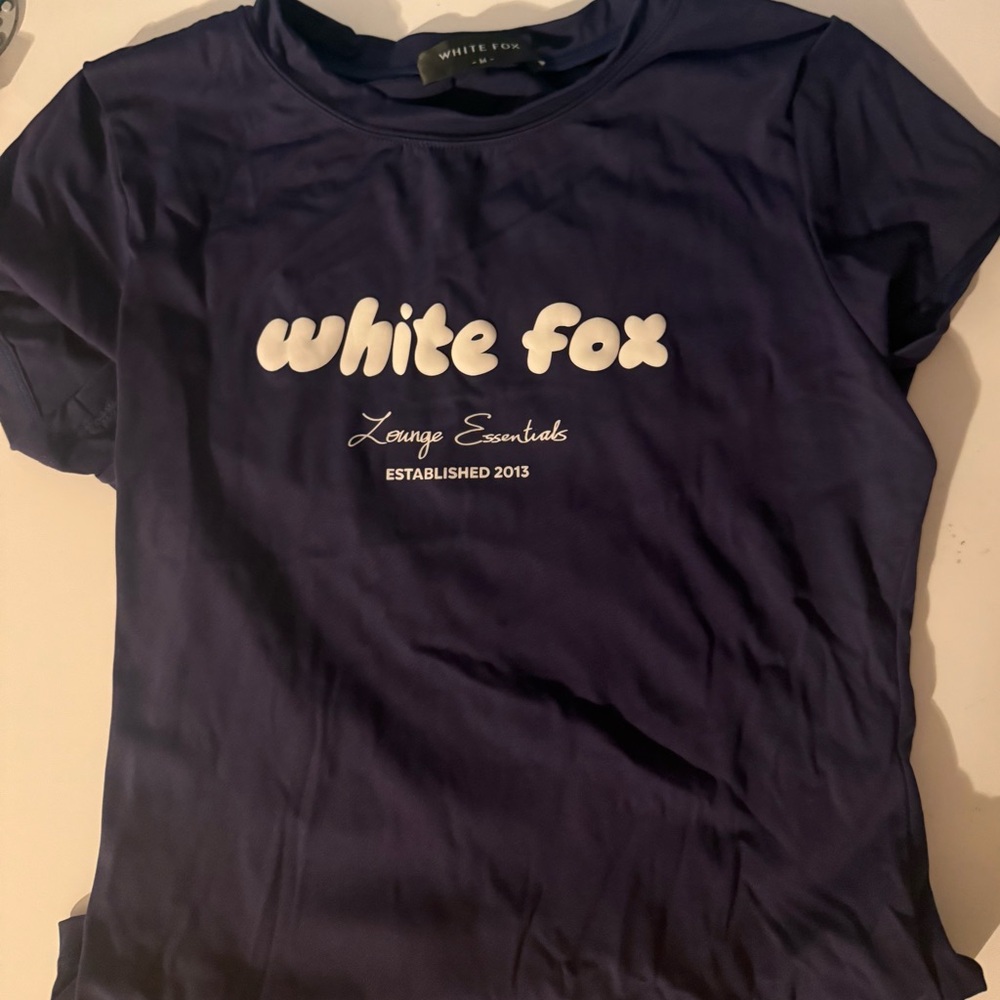 Medium navy blue white fox baby tee.